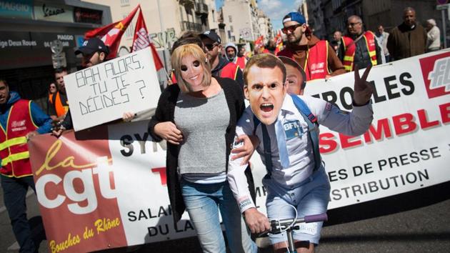 People wear masks depicting Emmanuel Macron and his wife Brigitte Trogneux during a May Day rally in Marseille. (AFP Photo) People wear masks depicting Emmanuel Macron and his wife Brigitte Trogneux during a May Day rally in Marseille. (AFP Photo)