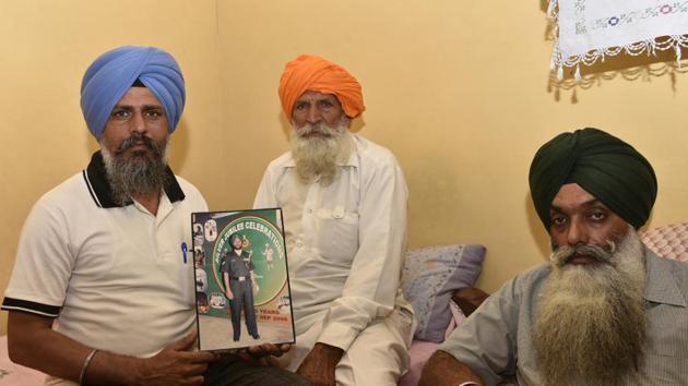 Udham singh (centre), father of naib subedar Paramjit Singh, and other family members at their residence in Vein Poin village of Tarn Taran district on Monday, May 1.(Gurpreet Singh/HT)