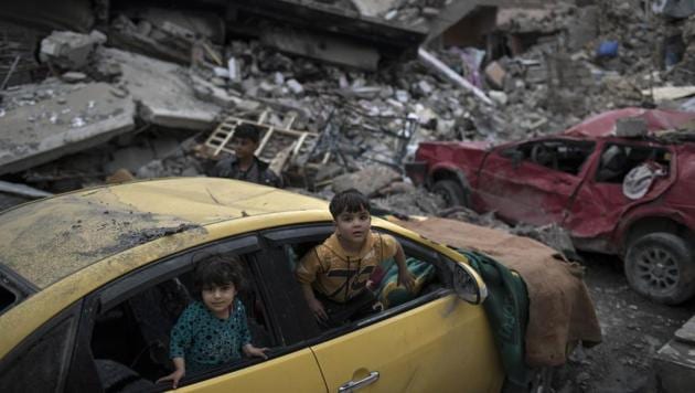 Children play inside a damaged car amid heavy destruction in a neighbourhood recently retaken by Iraqi security forces from Islamic State militants on the western side of Mosul.(AP) Children play inside a damaged car amid heavy destruction in a neighbourhood recently retaken by Iraqi security forces from Islamic State militants on the western side of Mosul.(AP)