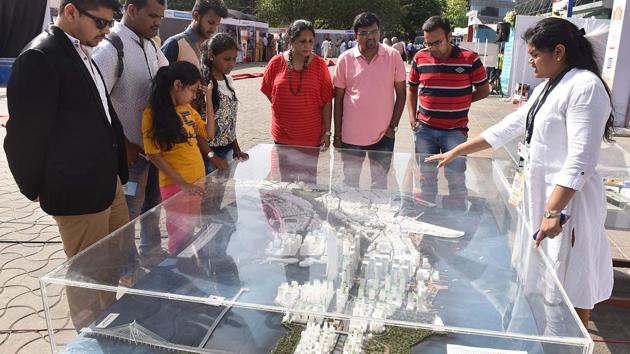 Visitors observe an exhibit at the Transform Maharashtra event at NSCI, Worli. (Pratham Gokhale//HT Photo)