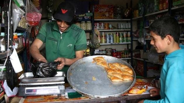 Parkour coach Ibrahim al-Kadiri, 19, works at his father's shop in the rebel-held city. (Alaa Al-Faqir / Reuters) Parkour coach Ibrahim al-Kadiri, 19, works at his father's shop in the rebel-held city. (Alaa Al-Faqir / Reuters)