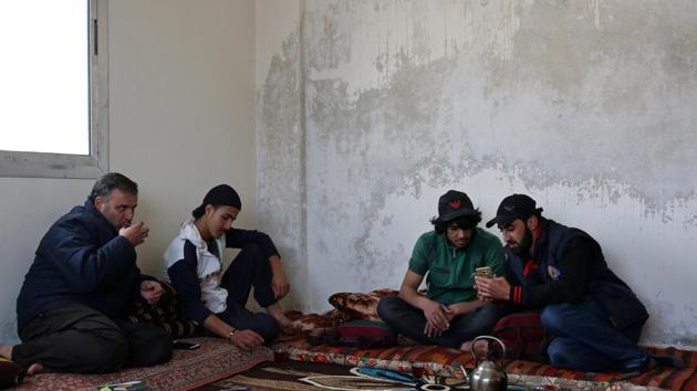 Parkour coach Ibrahim al-Kadiri, 19, drinks tea with his friends. (Alaa Al-Faqir / Reuters) Parkour coach Ibrahim al-Kadiri, 19, drinks tea with his friends. (Alaa Al-Faqir / Reuters)