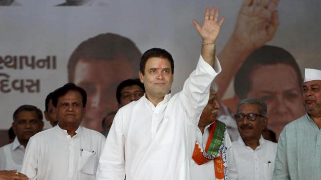 Congress vice president Rahul Gandhi waves at party workers during a public meeting at Dediapada village in Narmada district on Monday.(PTI)