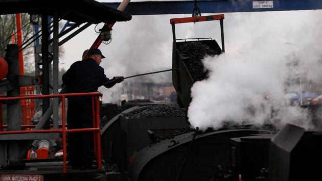 Workers put coal to the steam locomotive after the Parade. (Kacper Pempel / REUTERS)