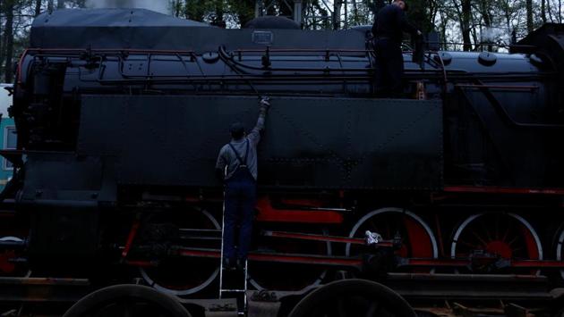 Workers prepare steam locomotive a day before the 24th Steam Engine Parade. (Kacper Pempel /REUTERS)