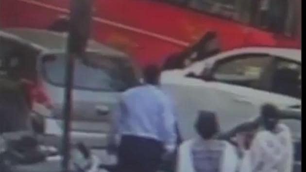 The video grab of the incident showing the man on the bonnet of the car.(ANI)