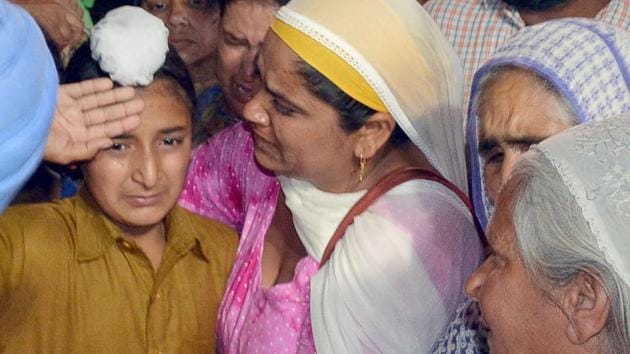 Martyr Paramjit Singh’s son Sahildeep Singh salutes his body at their house in Vein Poin village in Tarn Taran district on Tuesday, May 2. Pakistani forces killed two Indian soldiers and mutilated their bodies along the Line of Control on May 1. (Sameer Sehgal/HT)