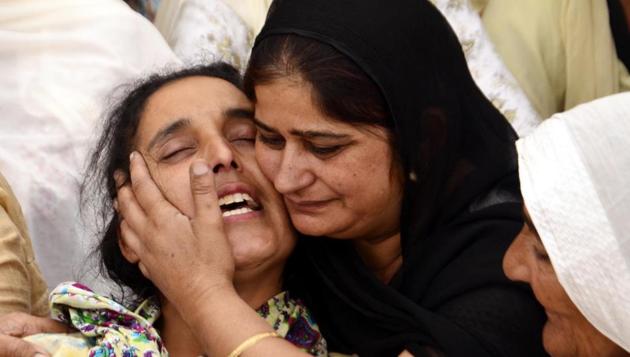 Martyr Paramjit Singh’s wife grieve is comforted by a woman at their house in Vein Poin village in Tarn Taran district on Tuesday, May 2. Pakistani forces killed two Indian soldiers and mutilated their bodies along the Line of Control on May 1 (Sameer Sehgal/HT)