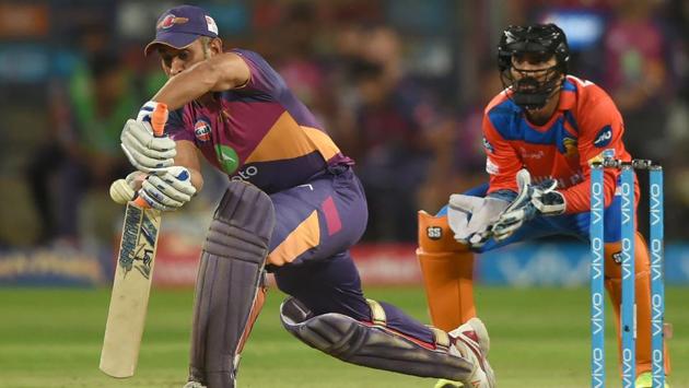 Rising Pune Supergiants cricketer Mahendra Singh Dhoni (L) watched by Gujarat Lions cricketer Dinesh Karthik plays a shot. (AFP) Rising Pune Supergiants cricketer Mahendra Singh Dhoni (L) watched by Gujarat Lions cricketer Dinesh Karthik plays a shot. (AFP)
