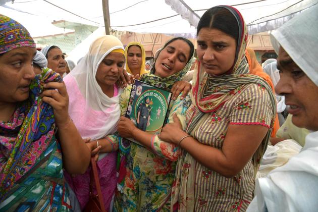Paramjeet Kaur (C), the wife of slain Indian Army soldier Paramjeet Singh, is supported by relatives as she cries during his funeral ceremony. Senior army officers and civil administration officials were also present as buglers sounded the ‘Last Post’ and the slain soldier was accorded a gun salute. (Narinder Nanu/AFP) Paramjeet Kaur (C), the wife of slain Indian Army soldier Paramjeet Singh, is supported by relatives as she cries during his funeral ceremony. Senior army officers and civil administration officials were also present as buglers sounded the ‘Last Post’ and the slain soldier was accorded a gun salute. (Narinder Nanu/AFP)