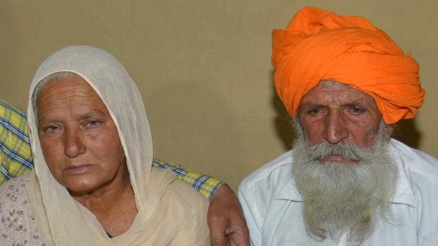 Udham Singh (R) and his wife Gurinder Kaur (L), father and mother of Indian Army soldier Paramjeet Singh cry as they hold a picture of their son at their residence AT Vein Pein village, some 45 km from Amritsar, on May 1, 2017.(AFP) Udham Singh (R) and his wife Gurinder Kaur (L), father and mother of Indian Army soldier Paramjeet Singh cry as they hold a picture of their son at their residence AT Vein Pein village, some 45 km from Amritsar, on May 1, 2017.(AFP)