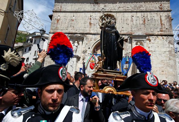 The procession is led by the priests and selected women carrying the ciambelli, which is bread that is designed to represent a snake biting its own tail. (Tony Gentile / Reuters)
