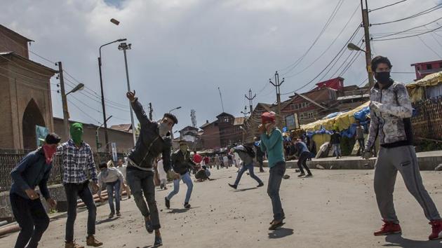 Masked Kashmiri protesters throw rocks and bricks at security forces during a protest in Srinagar. (AP Photo) Masked Kashmiri protesters throw rocks and bricks at security forces during a protest in Srinagar. (AP Photo)