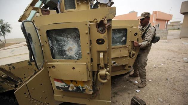 Iraqi soldiers stand next to their vehicle in the village of Huleileh, north of Mosul on May 1, 2017, during an offensive to retake the area from Islamic State.(AFP Photo) Iraqi soldiers stand next to their vehicle in the village of Huleileh, north of Mosul on May 1, 2017, during an offensive to retake the area from Islamic State.(AFP Photo)