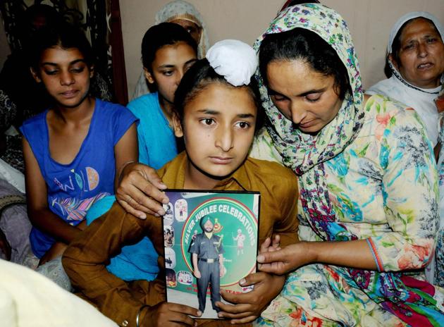 Wife Paramjit Kaur, son Sahildeep Singh and daughters Khushdeep Kaur (L) and Simardeep Kaur of late Naib Subedar Paramjit Singh wait for the arrival his mortal remains. The 42-year-old, who belonged to the army’s 22 Sikh Infantry, was one of the two soldiers beheaded by Pakistani troops on Monday. Head constable Prem Sagar of the BSF’s 200th battalion was the other soldier. (PTI) Wife Paramjit Kaur, son Sahildeep Singh and daughters Khushdeep Kaur (L) and Simardeep Kaur of late Naib Subedar Paramjit Singh wait for the arrival his mortal remains. The 42-year-old, who belonged to the army’s 22 Sikh Infantry, was one of the two soldiers beheaded by Pakistani troops on Monday. Head constable Prem Sagar of the BSF’s 200th battalion was the other soldier. (PTI)