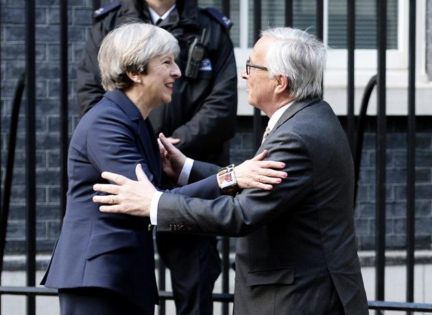 British Prime Minister Theresa May greets European Commission President Jean-Claude Juncker in London on April 26.(AP)