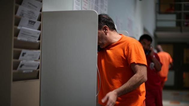 ICE detainees make phone calls at the center. (Lucy Nicholson /Reuters)