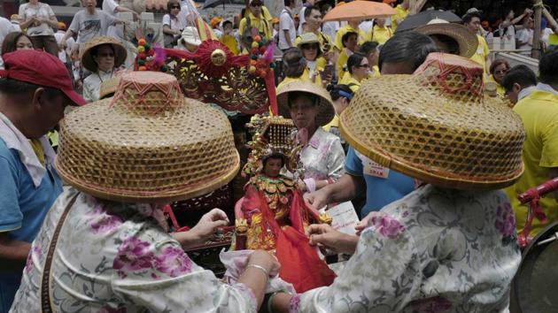Local residents dress a statue of a Chinese god on the outlying Cheung Chau island in Hong Kong to celebrate the Bun Festival. The festival is held every year to placate the spirits of people killed by pirates.  (Vincent Yu/AP) 