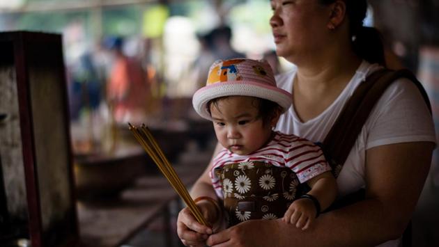 Instead, plastic buns lined a steel frame as part of safety measures brought in after an old-style structure -- made from bamboo and real buns -- collapsed in 1978 and caused injuries.  (Anthony Wallace/AFP) 