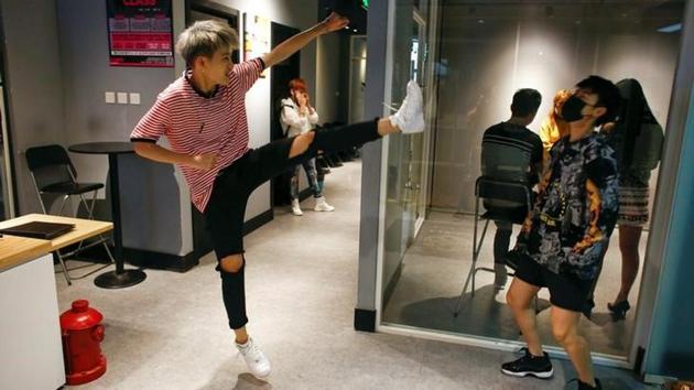 Members of China's all-girl ‘boyband’ FFC-Acrush wait for the start of a rehearsal at a dance studio. Members of China's all-girl ‘boyband’ FFC-Acrush wait for the start of a rehearsal at a dance studio.