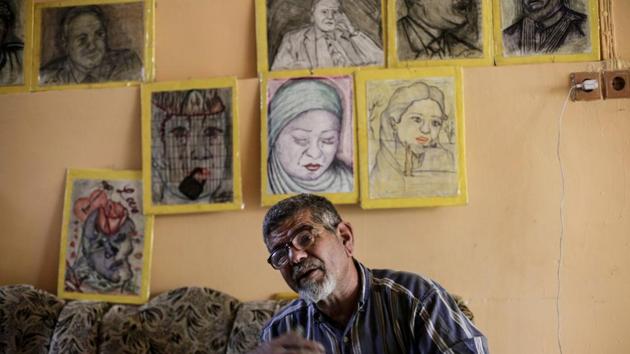 Iraqi painter Mustafa al-Taee sit in front of a display of his art work as he speaks to The Associated Press, at his home in the northern town of Hamam al-Alil, near Mosul, Iraq.(AP Photon) Iraqi painter Mustafa al-Taee sit in front of a display of his art work as he speaks to The Associated Press, at his home in the northern town of Hamam al-Alil, near Mosul, Iraq.(AP Photon)