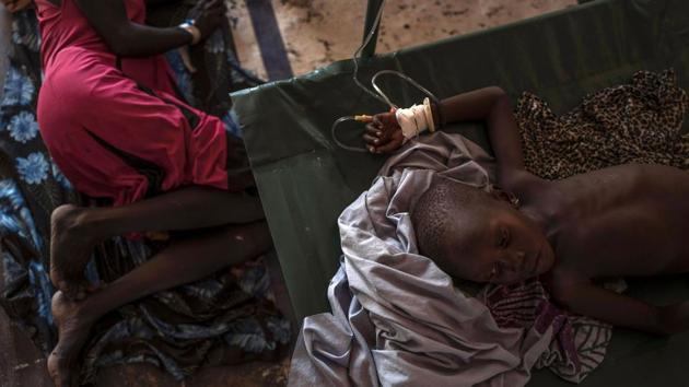 A South Sudanese patient suffering from cholera and malnutrition rests on a bed . (AFP)