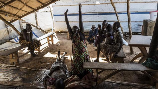 Relatives mourn the death of a family member due to the cholera crisis at the temporary hospital in Mingkaman, a camp. (AFP)
