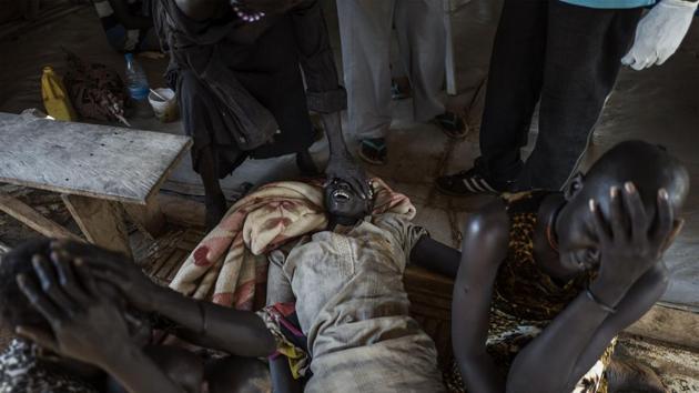 Relatives begin to mourn moments after a patient with cholera dies at the temporary specialized hospital in Mingkaman. (AFP)
