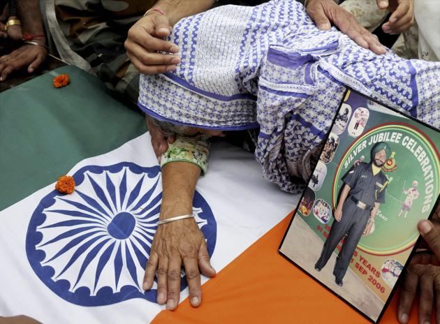 Naib subedar Paramjit Singh's mother breaks down as his body arrives in Vain Poin village in Punjab’s Amritsar on Tuesday. Singh was one of the two soldiers killed and mutilated in a cross-border raid by the Pakistan army a day earlier.(PTI photo)