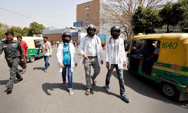 Doctors wear crash helmets outside the All India Institute Of Medical Sciences (AIIMS) during a protest to highlight the lack of security offered to doctors, in New Delhi, March 23(REUTERS)