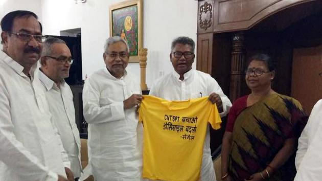 Bihar Chief Minister Nitish Kumar along with tribal leader and former MP Salkhan Murmu with a T-shirt displaying slogan against amendment in CNT and SPT Acts in Patna(HT Photo) Bihar Chief Minister Nitish Kumar along with tribal leader and former MP Salkhan Murmu with a T-shirt displaying slogan against amendment in CNT and SPT Acts in Patna(HT Photo)