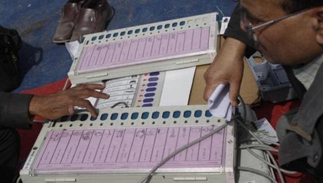 Polling officers check EVMs at a distribution centre ahead of the assembly polls in Uttar Pradesh. (HT File) Polling officers check EVMs at a distribution centre ahead of the assembly polls in Uttar Pradesh. (HT File)