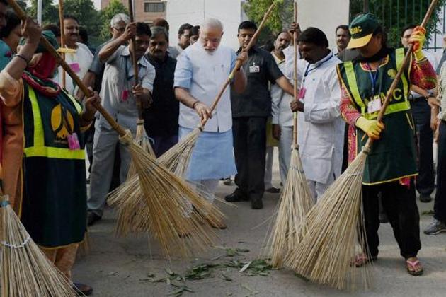 A file photo of Prime Minister Narendra Modi wielding a broom with NDMC workers to launch the 'Swachh Bharat Abhiyan' in New Delhi, 2014. (PTI) A file photo of Prime Minister Narendra Modi wielding a broom with NDMC workers to launch the 'Swachh Bharat Abhiyan' in New Delhi, 2014. (PTI)