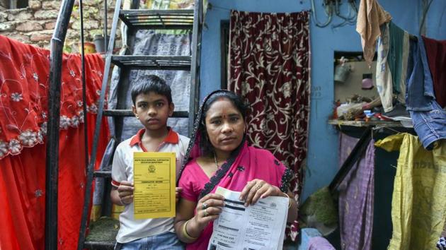 Swayam Gupta lost out on a school scholarship because his name is misspelt on his Aadhaar card. His bank passbook shows an entry of Rs 1,200 in his account. However, he cannot withdraw the money as his name in the Aadhaar card has been erroneously spelled as Shivam.(Arun Sharma/HT PHOTO)