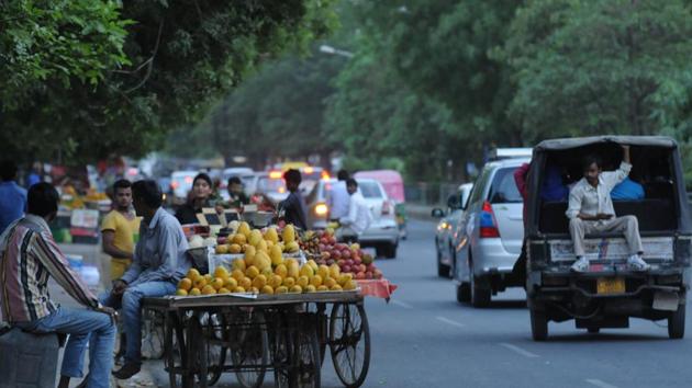 According to commuters, people stop in the middle of the road to purchase fruits and vegetables, blocking traffic.(Parveen Kumar/HT Photo)