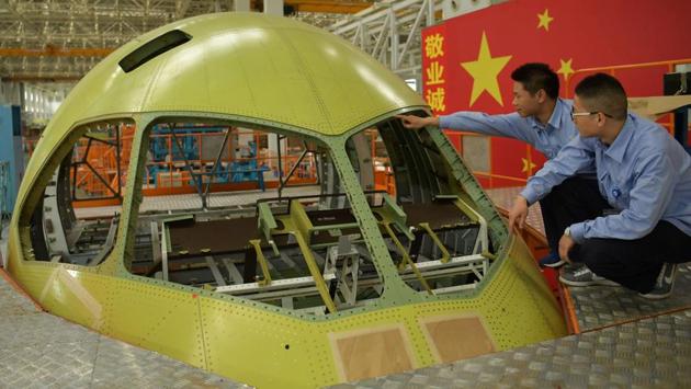 Workers at the construction site of the Chengdu Aircraft Industry plant in Chengdu, in Southwest China's Sichuan province. (AFP) Workers at the construction site of the Chengdu Aircraft Industry plant in Chengdu, in Southwest China's Sichuan province. (AFP)