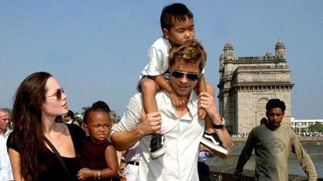 Angelina Jolie (L) holds daughter Zahara as husband and actor Brad Pitt (C) carries son Maddox during a stroll on the seafront promenade at the historic Gateway of India, (R) outside their hotel in Mumbai, 12 November 2006.(AFP) Angelina Jolie (L) holds daughter Zahara as husband and actor Brad Pitt (C) carries son Maddox during a stroll on the seafront promenade at the historic Gateway of India, (R) outside their hotel in Mumbai, 12 November 2006.(AFP)