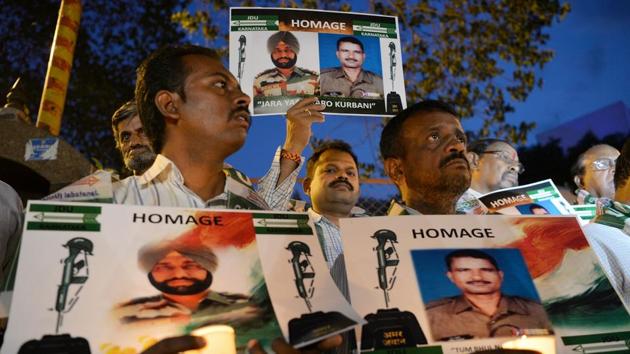 Activists stage a candlelight vigil in Bangalore to condemn the mutilation of Indian soldiers' bodies by Pakistani soldiers in Kashmir. (AFP Photo) Activists stage a candlelight vigil in Bangalore to condemn the mutilation of Indian soldiers' bodies by Pakistani soldiers in Kashmir. (AFP Photo)