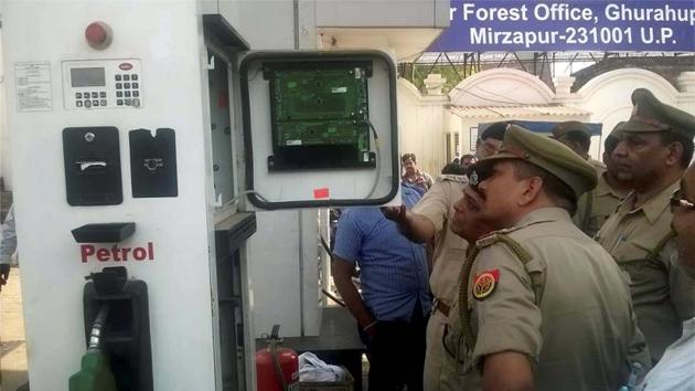 Police officers checking a petrol pump machine in Mirzapur, Uttar Pradesh, May 1. The way technology was being used to pilfer petrol and diesel in the state makes it clear that the rights of the average consumer are not safe anywhere. (PTI) Police officers checking a petrol pump machine in Mirzapur, Uttar Pradesh, May 1. The way technology was being used to pilfer petrol and diesel in the state makes it clear that the rights of the average consumer are not safe anywhere. (PTI)