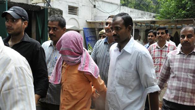 The minor accused (face covered) in being produced in court.(Sushil Kumar/HT File Photo)