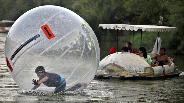 A child enjoys inside a floating ball at Old fort boat club in the summer of 2015 when the water levels in the lake was normal. (Raj K Raj/HT PHOTO)