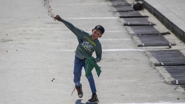 A young Kashmiri protester throws stones at government forces during a protest in Srinagar, Jammu and Kashmir, Friday, May 5, 2017.(AP)