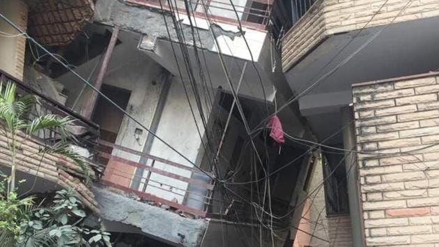 The under-contruction building collapsed on to another in Inderpuri in west Delhi, trapping five people who were rescued later.(HT PHOTO)