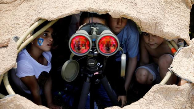 Israeli children look through binoculars during a display of Israeli Defense Forces equipment and abilities, as part of the celebrations for Israel's Independence Day marking the 69th anniversary, in the southern city of Sderot. (Amir Cohen/REUTERS)