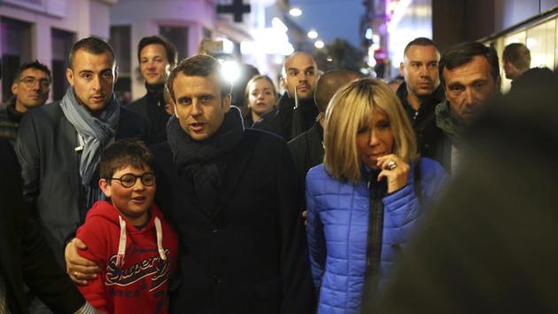 French independent centrist presidential candidate, Emmanuel Macron and his wife Brigitte walk in a street of Le Touquet, northern France on Saturday.(AP) French independent centrist presidential candidate, Emmanuel Macron and his wife Brigitte walk in a street of Le Touquet, northern France on Saturday.(AP)