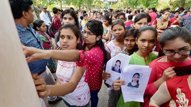 Aspirants with their admit cards before a National Eligibility-Cum-Entrance Test (NEET), in Bhopal. (PTI) Aspirants with their admit cards before a National Eligibility-Cum-Entrance Test (NEET), in Bhopal. (PTI)