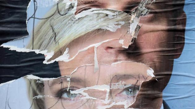 Torn and overlapping official posters of candidates for the 2017 French presidential election Marine Le Pen of French National Front (FN) political party, and Emmanuel Macron, head of the political movement ‘En Marche’ are seen in Cambrai. (Pascal Rossignol/REUTERS)