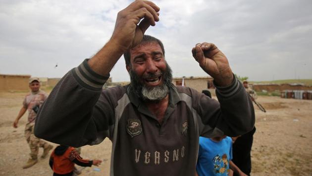 Displaced Iraqis from the al-Haramat neighbourhood, north of Mosul, react as Iraqi forces advance towards the area during the ongoing offensive to retake Mosul from Islamic State (IS) group fighters. Iraqi forces thrust into west Mosul from the north, opening a new front in the more than six-month-old offensive to dislodge the Islamic State group from the country's second city. (Ahmad al-Rubaye/AFP)