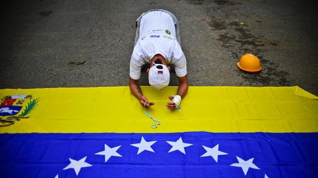 Venezuelan opposition activists attend a march against President Nicolas Maduro, in Caracas. May Day protests risk being rough in Venezuela as it marks one month since deadly clashes erupted in a political crisis with no end in sight. Protesters took to the streets from April 1 to demand elections after the courts tried to strengthen President Nicolas Maduro's grip on power. (Ronaldo Schemidt/AFP)
