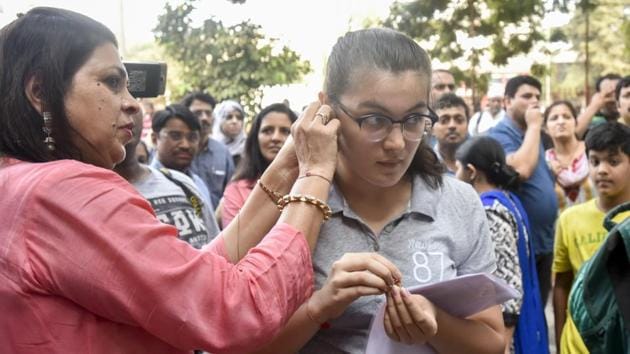 A student gets her earrings removed before entering the examination hall to take the NEET on Sunday. (Kunal Patil/HT Photo) A student gets her earrings removed before entering the examination hall to take the NEET on Sunday. (Kunal Patil/HT Photo)